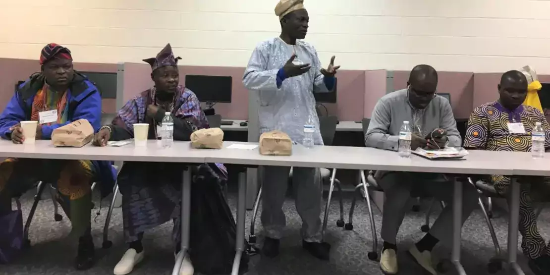 Man standing behind a table speaking