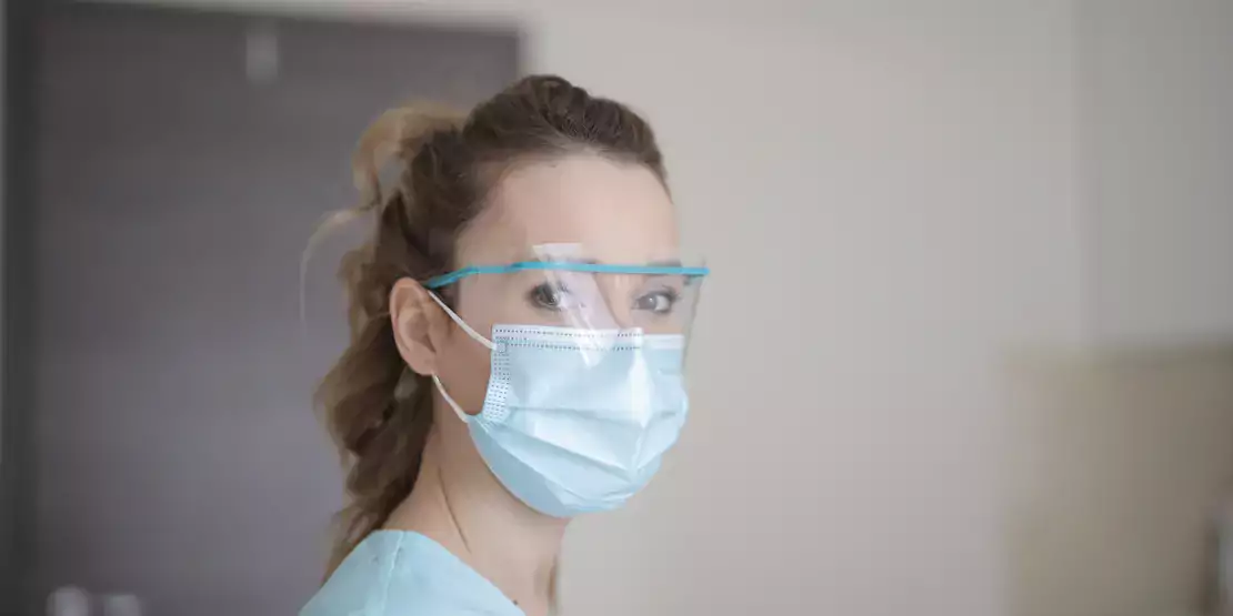 Woman wearing a mask and safety glasses