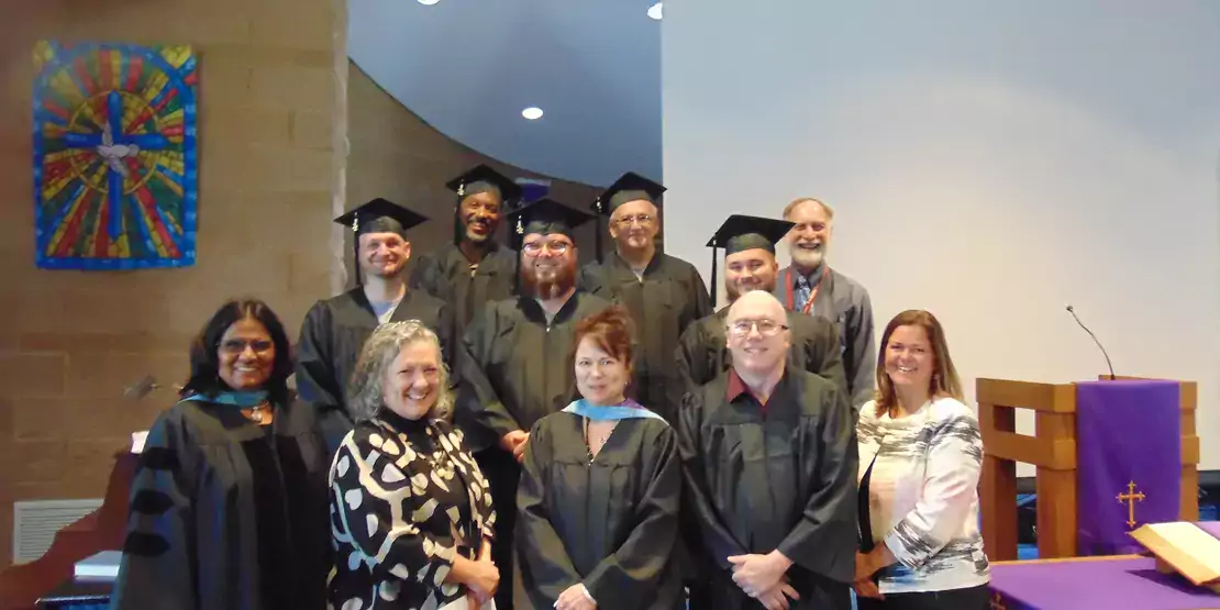 A group of Craggy graduates standing on stairs