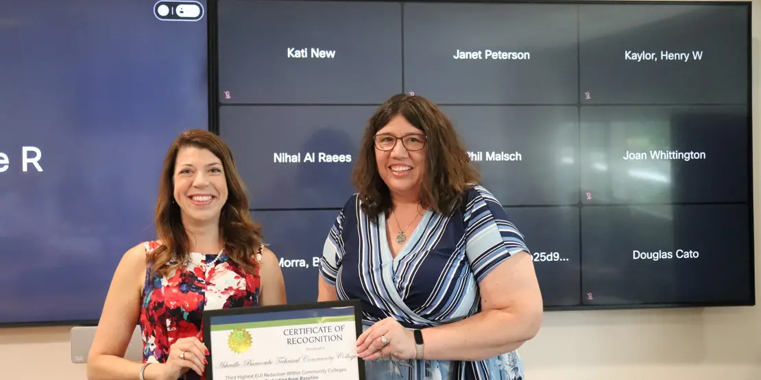 Elizabeth Bizer (left) awards A-B Tech Facilities Director Elizabeth Green with Energy Award 