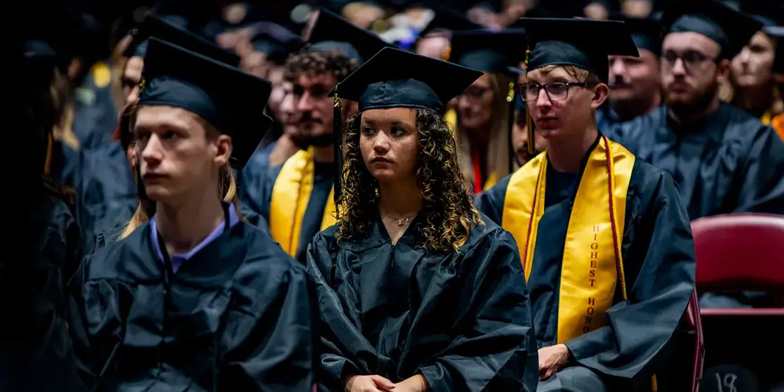 A-B Tech graduates listen as Gov. Josh Stein speaks inside Harrah's Cherokee Center during the university's graduation ceremony, May 10, 2025, in Asheville.