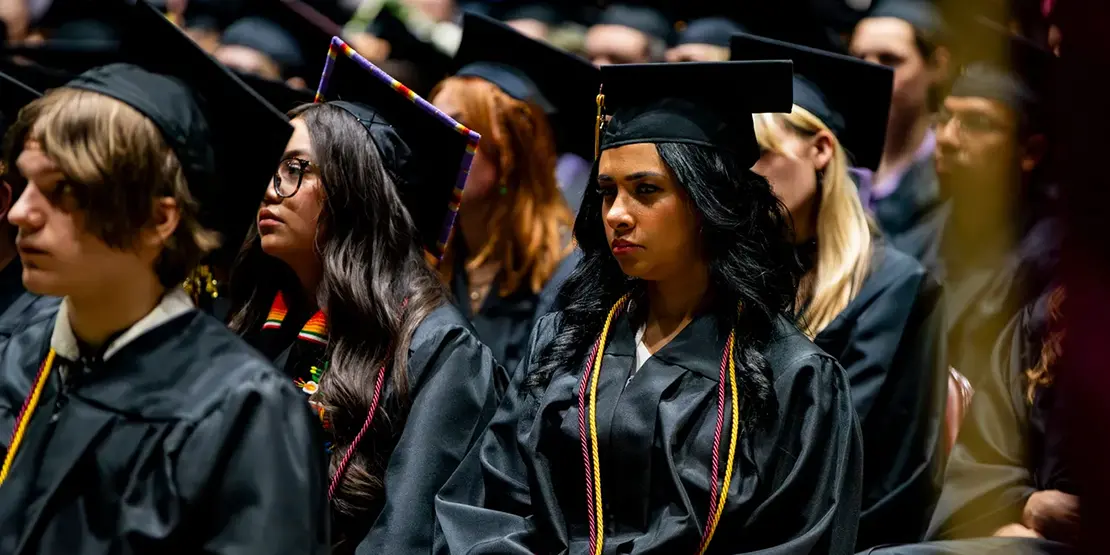 A-B Tech graduates listen as Gov. Josh Stein speaks inside Harrah's Cherokee Center during the university's graduation ceremony, May 10, 2025, in Asheville.