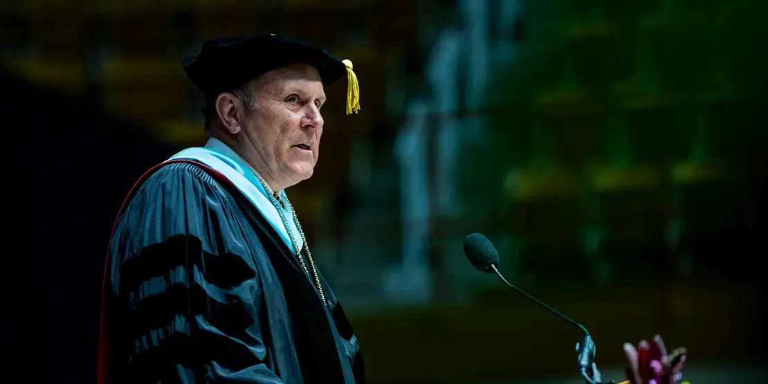 A-B Tech President Dr. John D. Gossett speaks inside Harrah's Cherokee Center during the university's graduation ceremony, May 10, 2025, in Asheville.