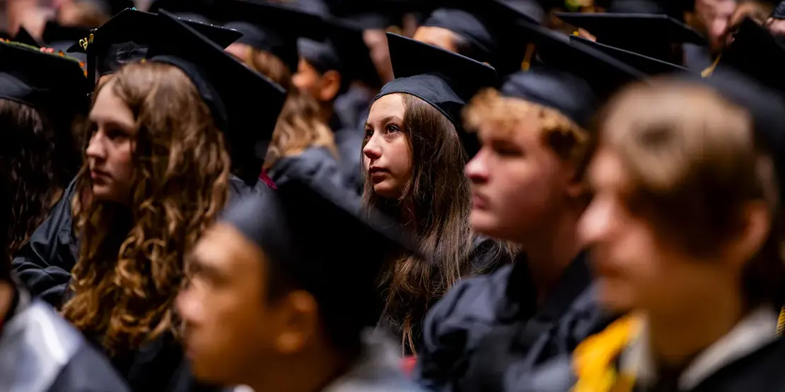 Graduates listen as A-B Tech President Dr. John D. Gossett speaks inside Harrah's Cherokee Center during the university's graduation ceremony, May 10, 2025, in Asheville.