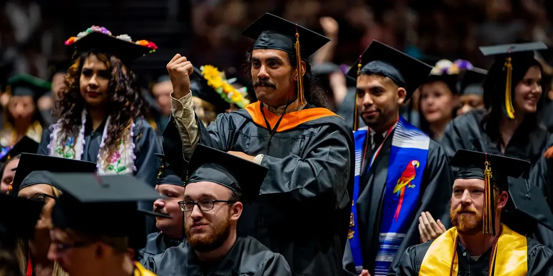 Graduates listen as A-B Tech President Dr. John D. Gossett speaks inside Harrah's Cherokee Center during the university's graduation ceremony, May 10, 2025, in Asheville.