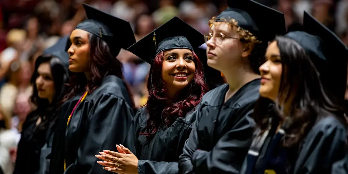 Graduates listen as A-B Tech President Dr. John D. Gossett speaks inside Harrah's Cherokee Center during the university's graduation ceremony, May 10, 2025, in Asheville.