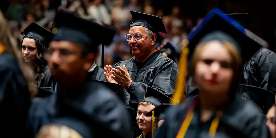 Graduates listen as A-B Tech President Dr. John D. Gossett speaks inside Harrah's Cherokee Center during the university's graduation ceremony, May 10, 2025, in Asheville.