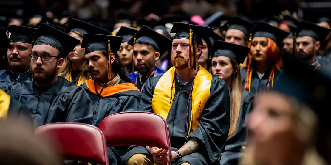 A-B Tech graduates listen as Nation Hahn delivers the commencement address inside Harrah's Cherokee Center during the university's graduation ceremony, May 10, 2025, in Asheville.