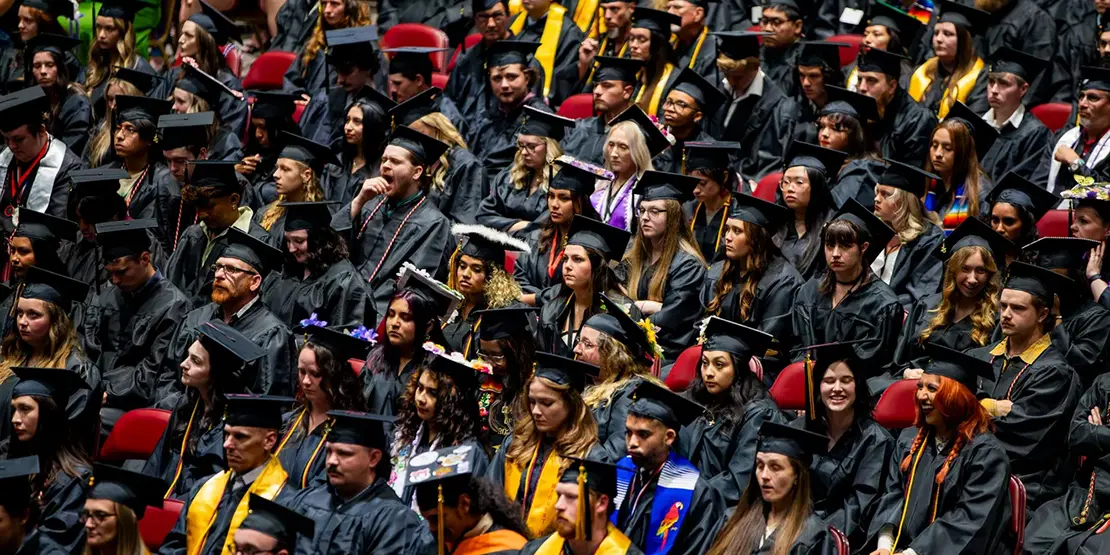 A-B Tech graduates listen as Nation Hahn delivers the commencement address inside Harrah's Cherokee Center during the university's graduation ceremony, May 10, 2025, in Asheville.