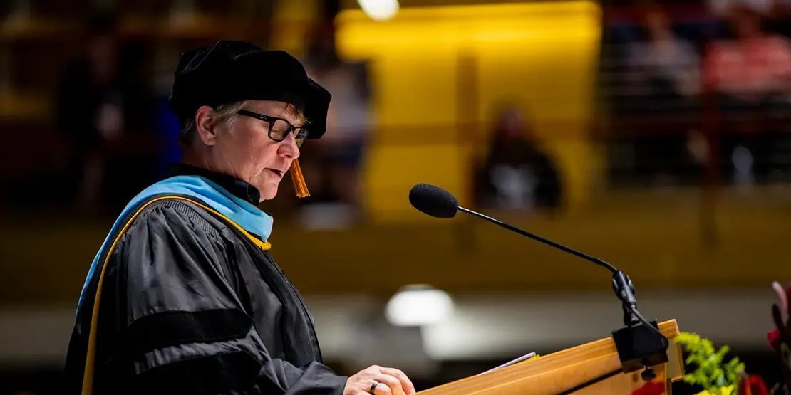 A-B Tech Vice President of Instructional Services Beth Stewart speaks inside Harrah's Cherokee Center during A-B Tech's graduation ceremony, May 10, 2025, in Asheville.