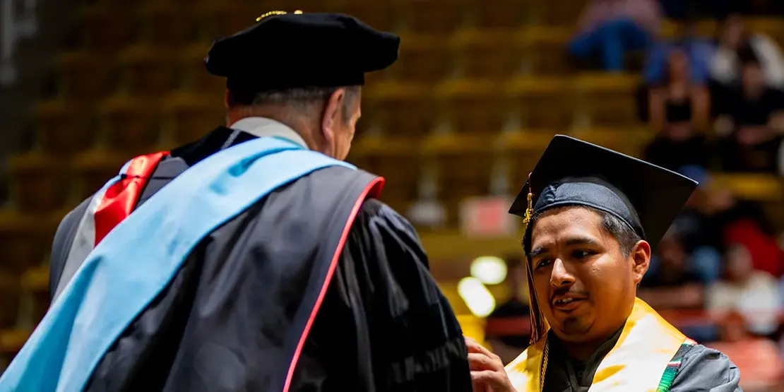 A-B Tech President Dr. John D. Gossett presents graduates with their diplomas inside Harrah's Cherokee Center during the university's graduation ceremony, May 10, 2025, in Asheville.