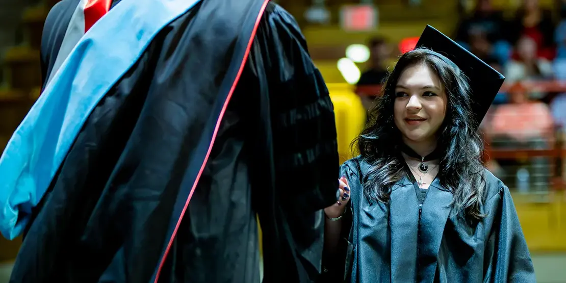 A-B Tech President Dr. John D. Gossett presents graduates with their diplomas inside Harrah's Cherokee Center during the university's graduation ceremony, May 10, 2025, in Asheville.