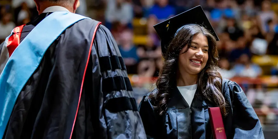 A-B Tech President Dr. John D. Gossett presents graduates with their diplomas inside Harrah's Cherokee Center during the university's graduation ceremony, May 10, 2025, in Asheville.