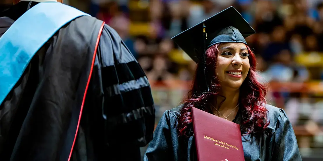 A-B Tech President Dr. John D. Gossett presents graduates with their diplomas inside Harrah's Cherokee Center during the university's graduation ceremony, May 10, 2025, in Asheville.