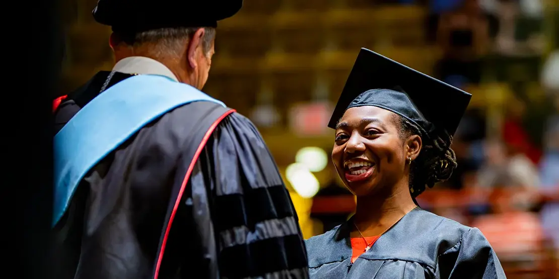 A-B Tech President Dr. John D. Gossett presents graduates with their diplomas inside Harrah's Cherokee Center during the university's graduation ceremony, May 10, 2025, in Asheville.