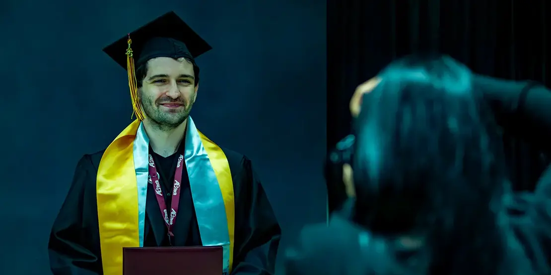 A-B Tech graduates pose for photos with their diplomas inside Harrah's Cherokee Center during the university's graduation ceremony, May 10, 2025, in Asheville.