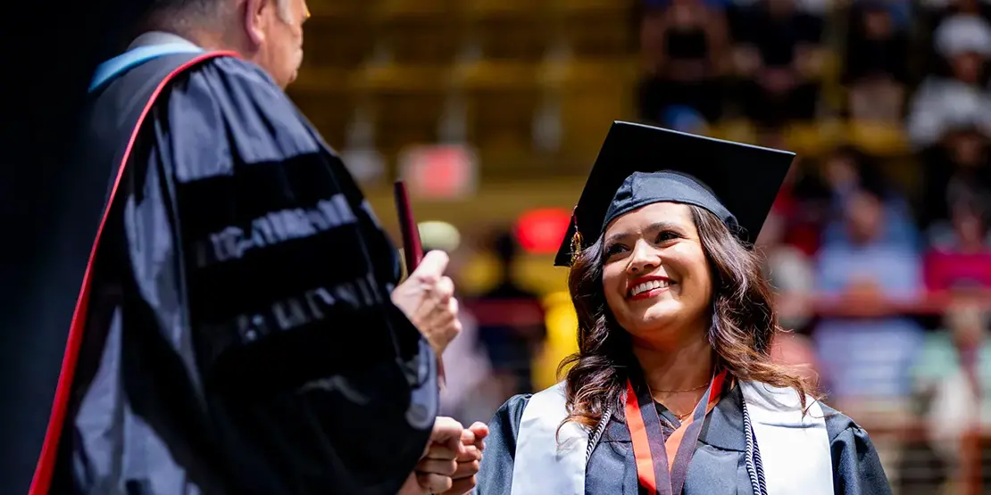 A-B Tech President Dr. John D. Gossett presents graduates with their diplomas inside Harrah's Cherokee Center during the university's graduation ceremony, May 10, 2025, in Asheville.