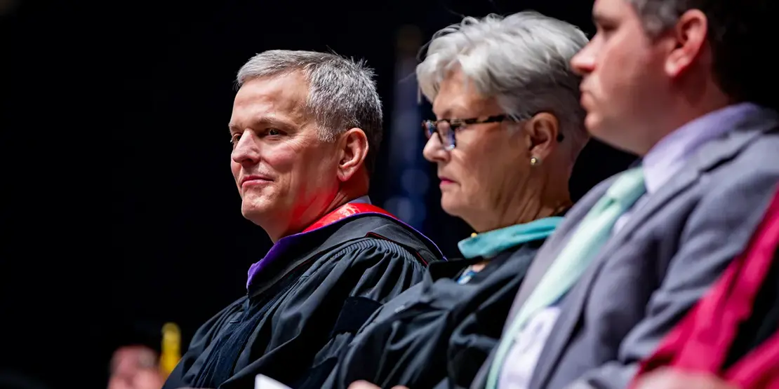 Gov. Josh Stein sits onstage inside Harrah's Cherokee Center during A-B Tech's graduation ceremony, May 10, 2025, in Asheville.