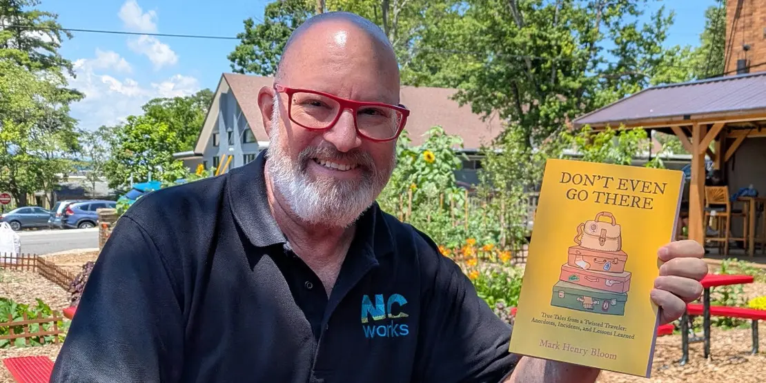 Mark Bloom holding his book