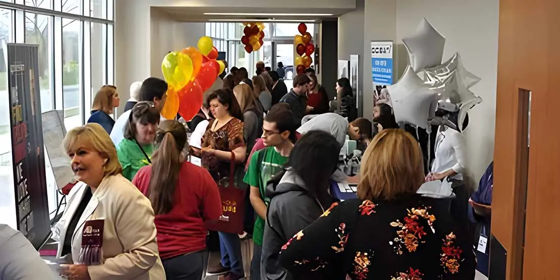 People in Hallway with Career Booths at Find Your Future Open House