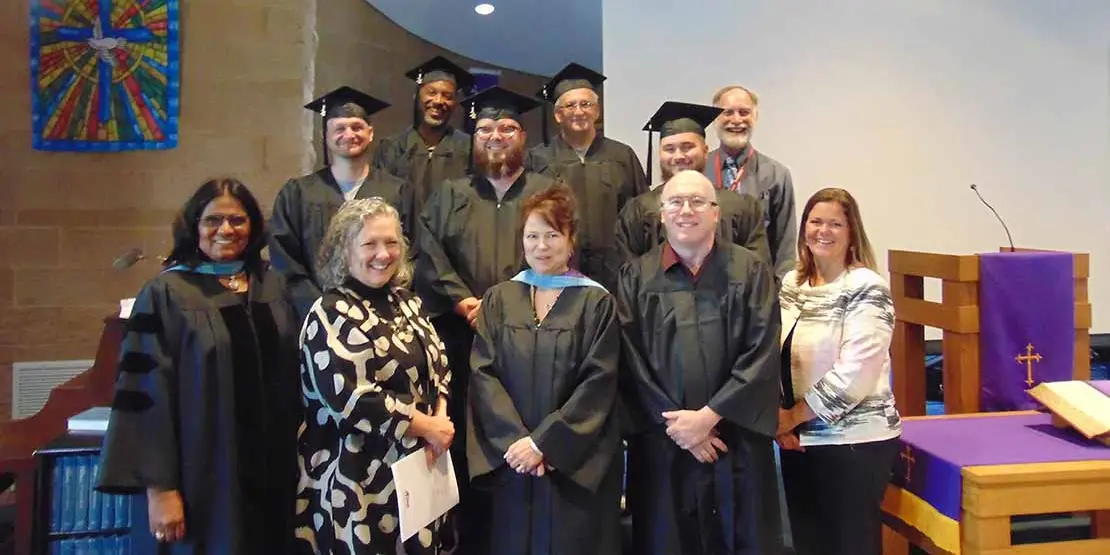 A group of Craggy graduates standing on stairs