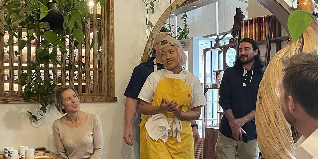 Woman in yellow apron in restaurant