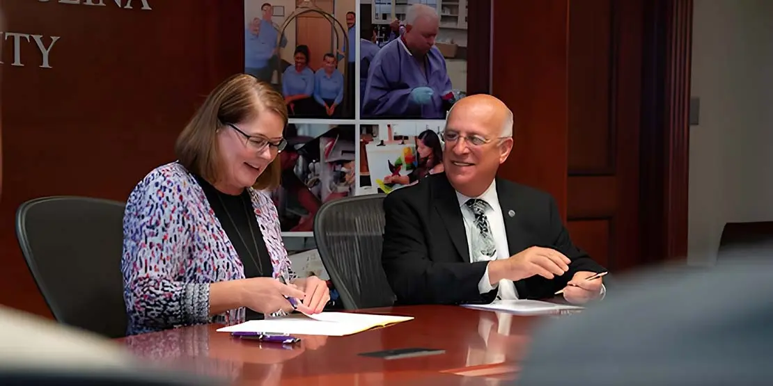Kelli Brown and Dennis King signing WCU admission agreement