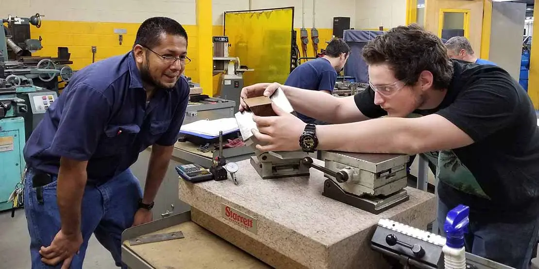 Two men working on a machine