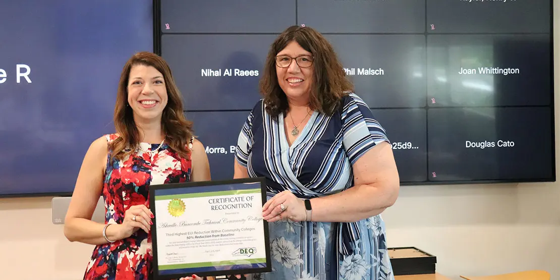 Elizabeth Bizer (left) awards A-B Tech Facilities Director Elizabeth Green with Energy Award 