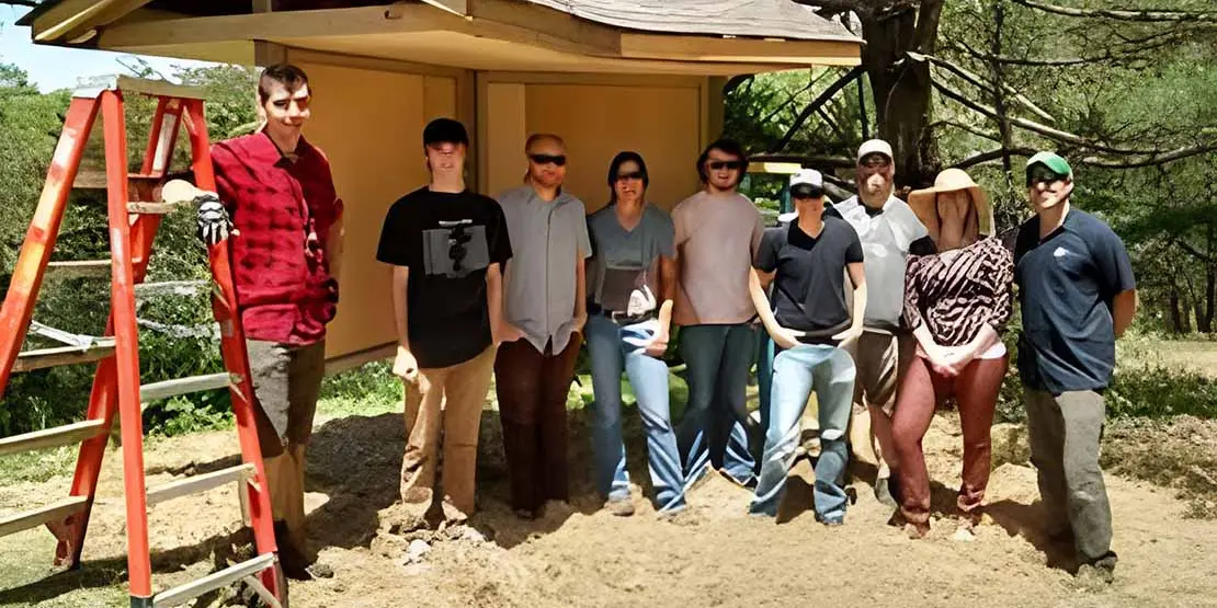Construction I standing in front of a kiosk outdoors.