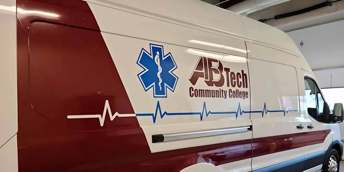 An ambulance with the A-B Tech logo