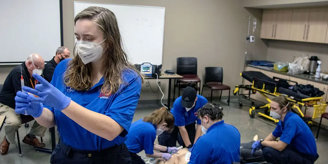 EMS students working on mannequin in the classroom.