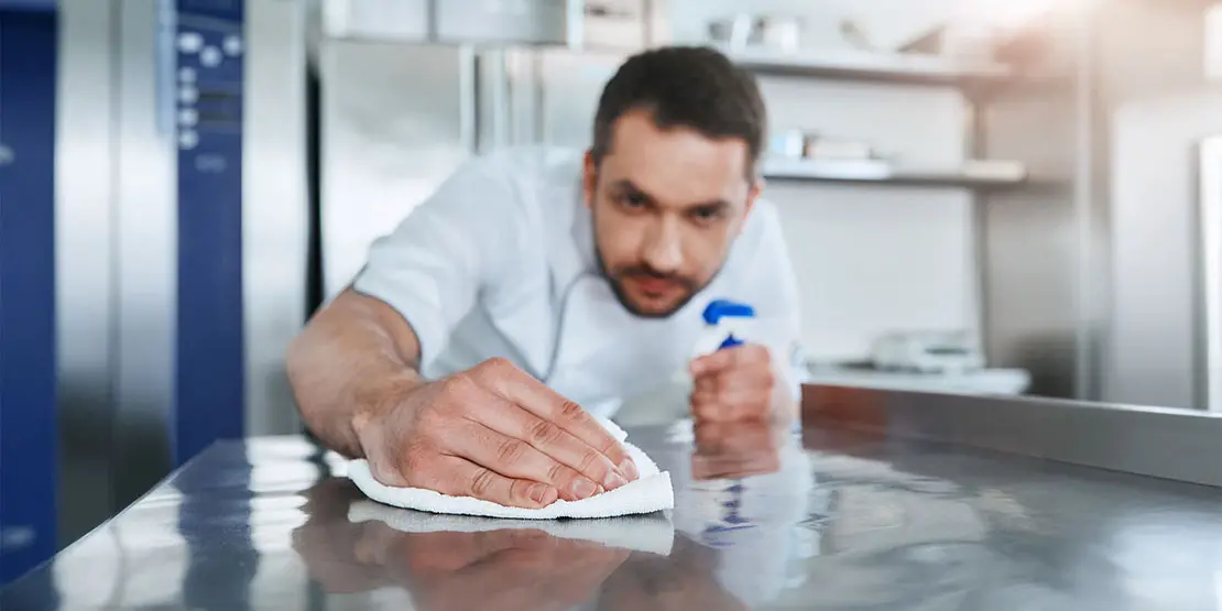 Man cleaning counter top