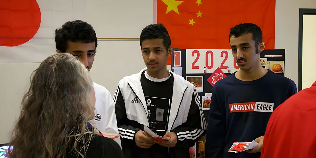 3 men and a woman at a booth