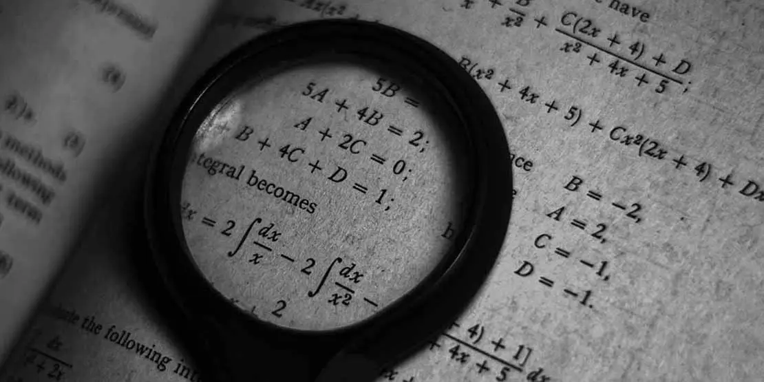 Magnifying glass on a math textbook