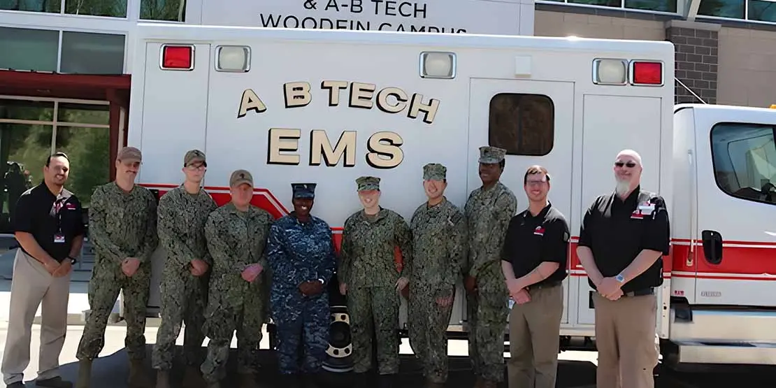 10 men and women standing in front of A-B Tech ambulance