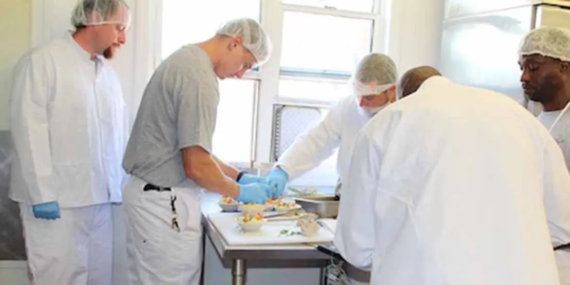 Four men working in a kitchen