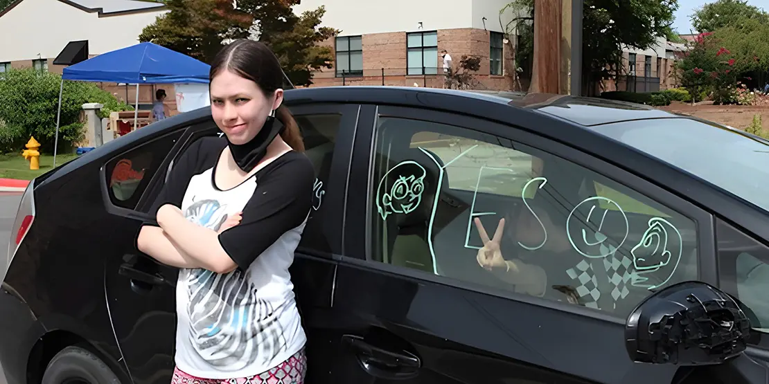 Gabriella Kusz stands next to her mother's car