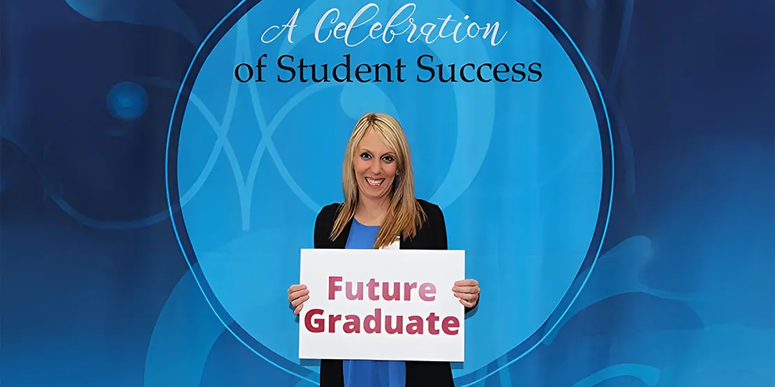 Bridget Cain holding sign that says Future Graduate