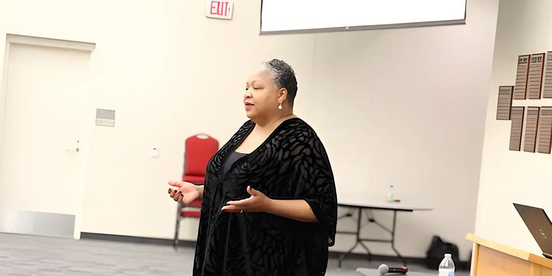 Jacqueline Whittenburg standing in front of room