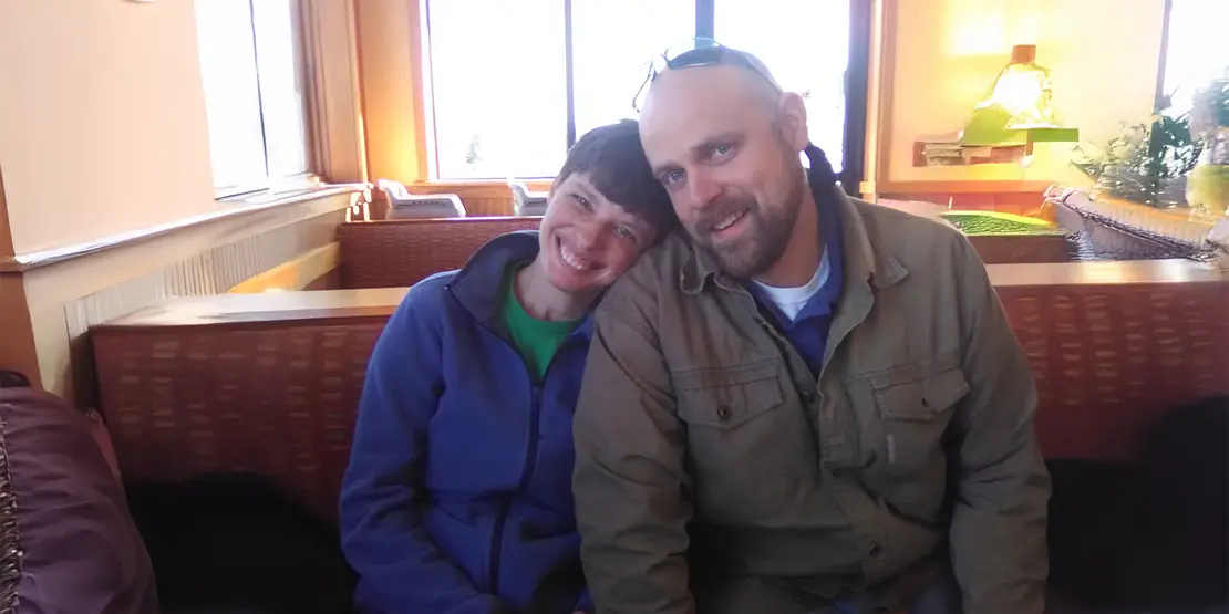 Man and women sitting close together smiling