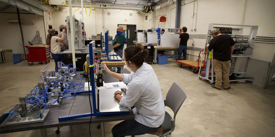 Person working at a station in a laboratory