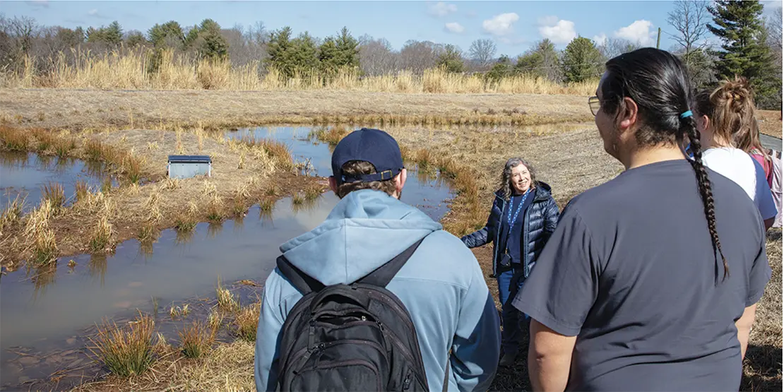 Helen Burrell and students at retention pond