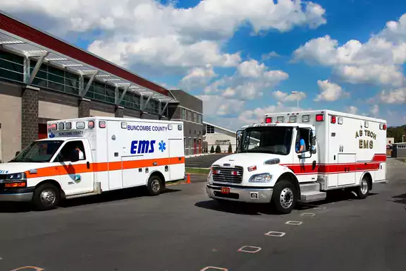 Two EMS vehicles in a parking lot