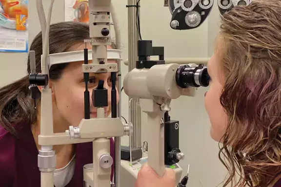 An ophthalmic student checking a patient