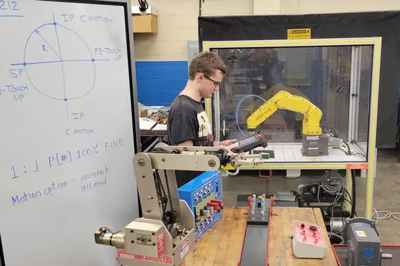 Student Using Robot Arm