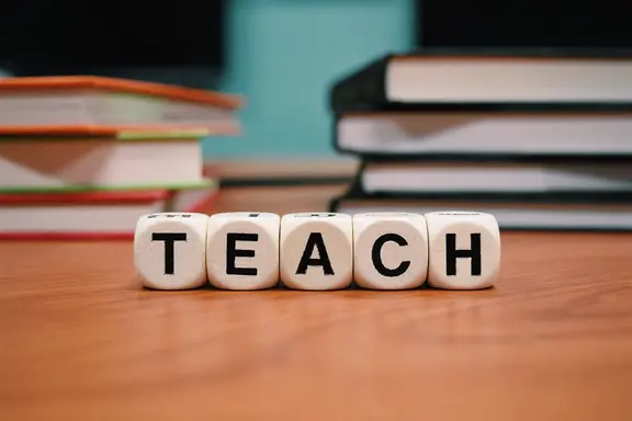 Desk with Teach spelled out in blocks