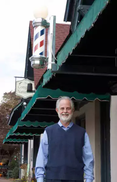 Man stading outside a barbershop