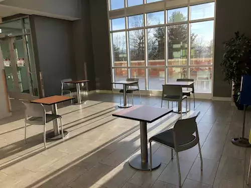 Single tables and chairs in a room