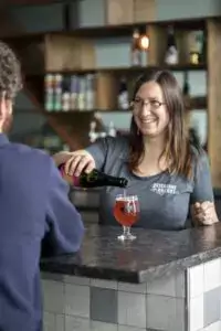 Woman pouring a drink at a bar